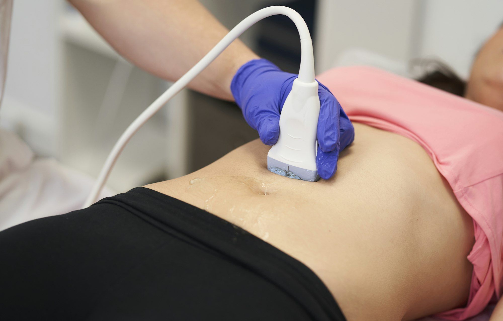 a physiotherapist performing an ultrasound scan for pelvic floor treatment