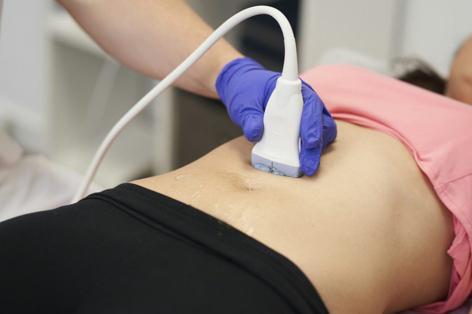 a physiotherapist performing an ultrasound scan for pelvic floor treatment